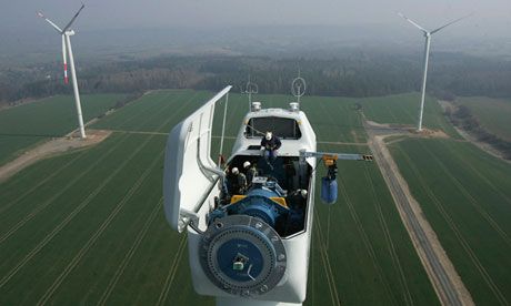 Wide view of a wind energy facility with multiple turbines operating in an open landscape, showcasing sustainable power generation.