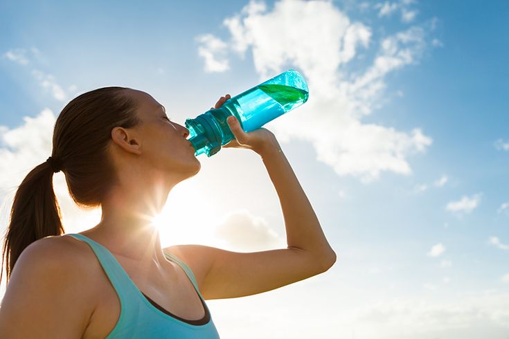 Woman staying refreshed with safe drinking water for hydration